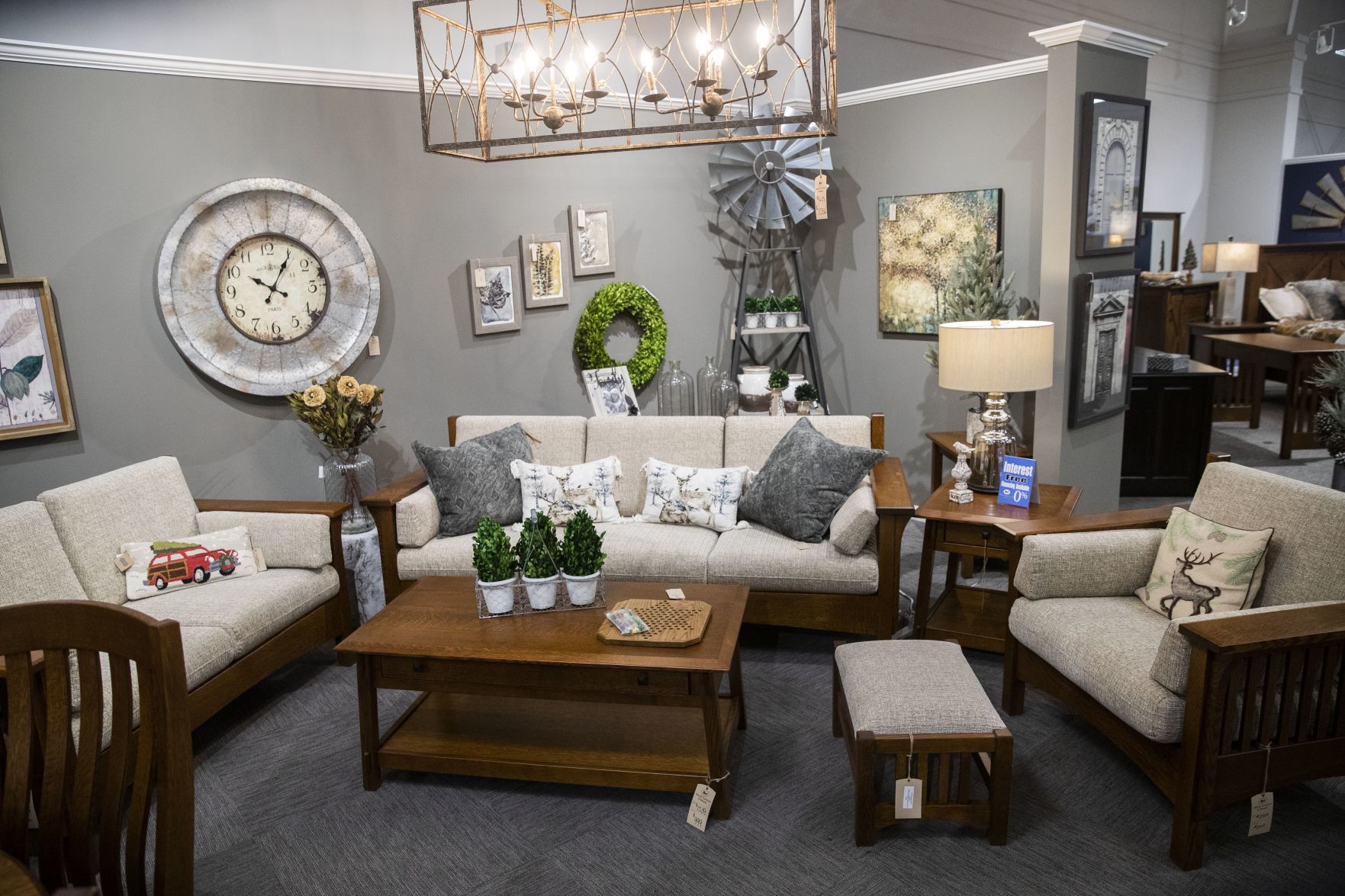 Living room decor and furniture is displayed on the showroom floor.